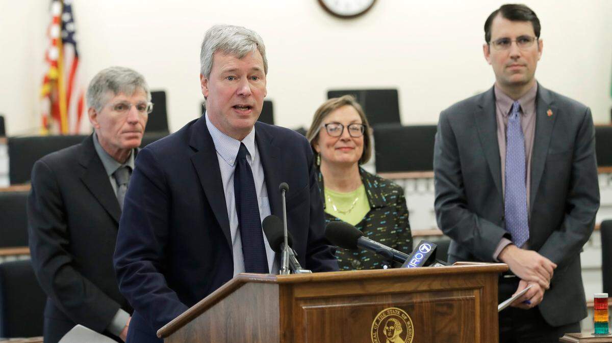 House Majority Leader Pat Sullivan, D-Covington, second from left, stands with other lawmakers as they talk about the release of their 2021 supplemental budget at a news conference at the Capitol. Sullivan announced Wednesday he is not seeking re-election.