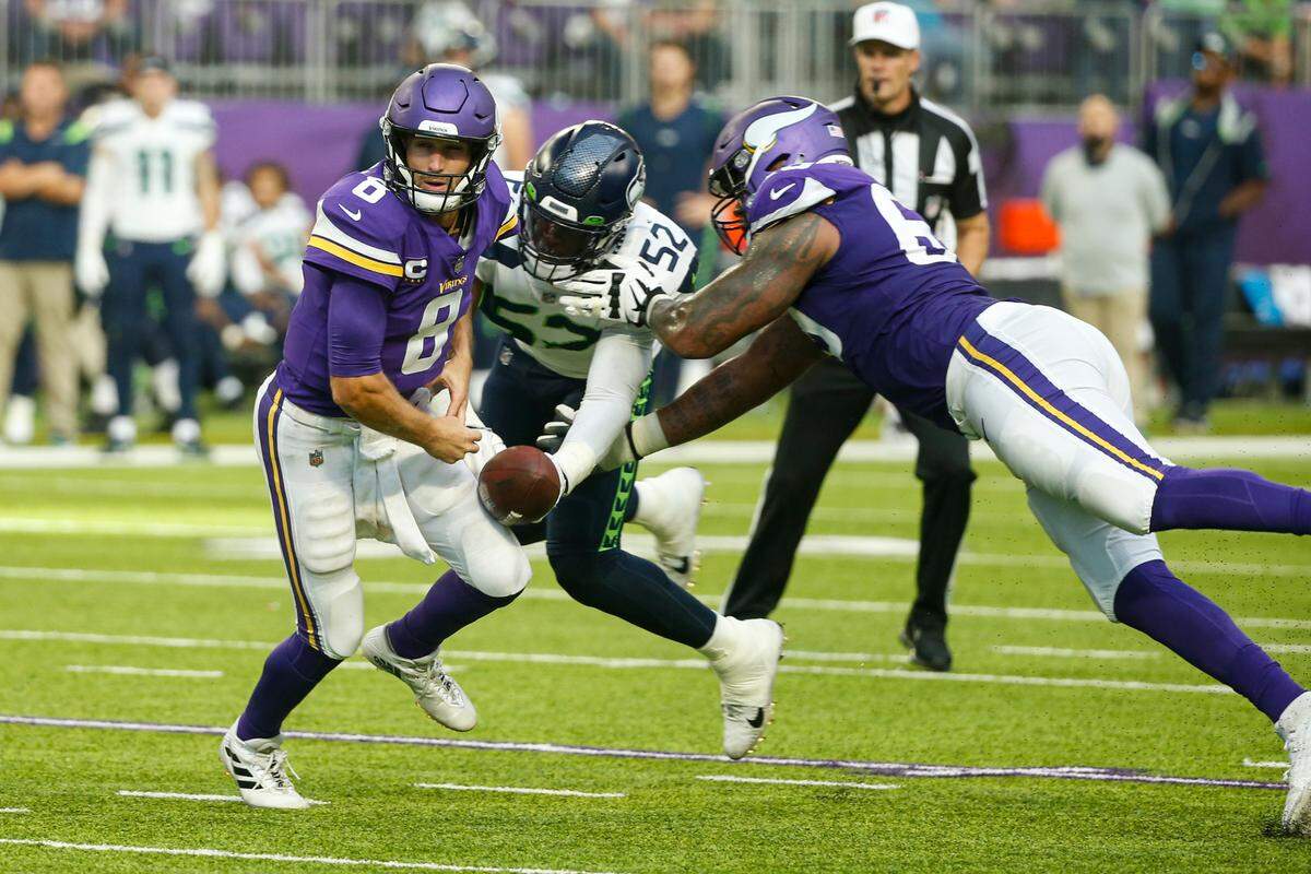 Seattle Seahawks defensive end Darrell Taylor (52) strips the ball from Minnesota Vikings quarterback Kirk Cousins (8) in the second half of an NFL football game in Minneapolis, Sunday, Sept. 26, 2021. Cousins the ball. (AP Photo/Bruce Kluckhohn)