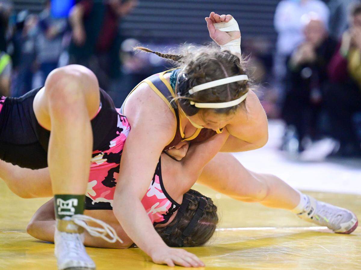 White River’s Shelby Moore prepares to pin Marysville Pilchuck’s Juju Kilroy during their 130-pound girls championship match at Mat Classic XXXIII on Saturday, Feb. 19, 2022, at the Tacoma Dome in Tacoma, Wash. Moore, who finished the season undefeated at 27-0, pinned Kilroy in 1 minute, 54 seconds.