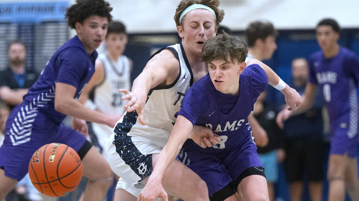 Gig Harbor’s Ty Buchanan has the ball knocked loose by North Thurston defender Liam Sheeran during Friday night’s 3A SSC boys basketball game at Gig Harbor High School in Gig Harbor, Washington, Jan. 5, 2024. After a fourth-quater rally by Gig Harbor tied the game at 45-45 in the final three minutes, North Thurston pulled away to win the game, 56-45.