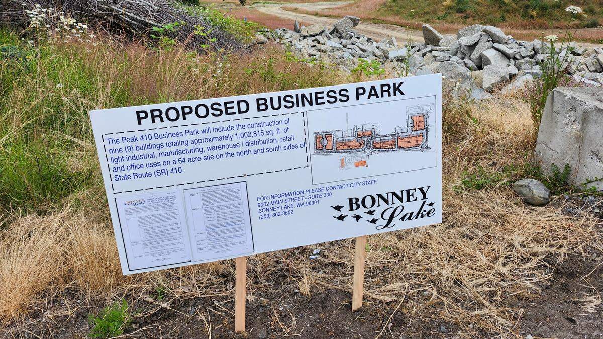 A sign offers public notice about the Peak 410 business park project along state Route 410 in Pierce County.