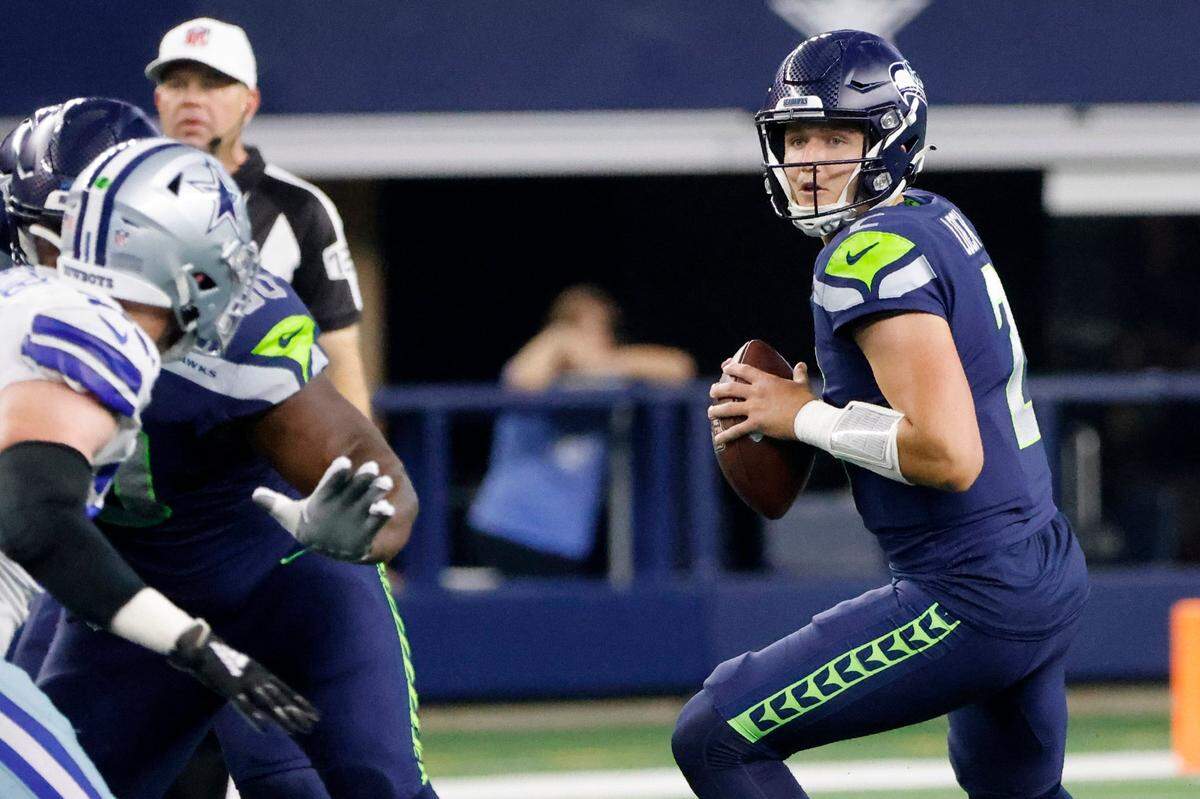 Seattle Seahawks quarterback Drew Lock (2) drops back to throw a pass in the first half of a preseason NFL football game against the Dallas Cowboys in Arlington, Texas, Friday, Aug. 26, 2022. (AP Photo/Michael Ainsworth)