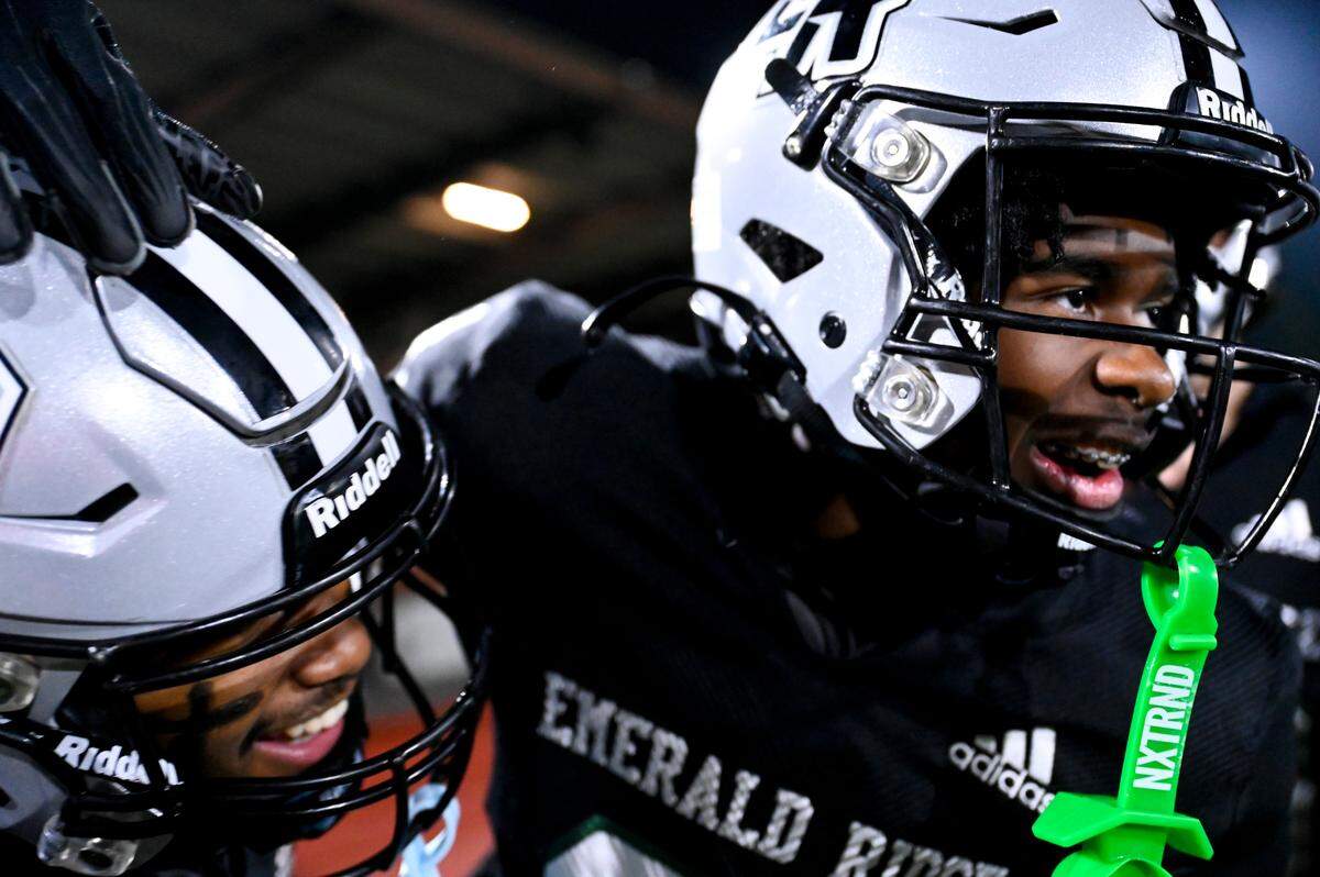 Emerald Ridge players reacts to a Emerald Ridge’s Malakai Harris (3) touchdown during the second half of the game against Graham-Kapowsin at Sparks Stadium, Saturday, Oct. 21, 2023, in Puyallup, Wash.