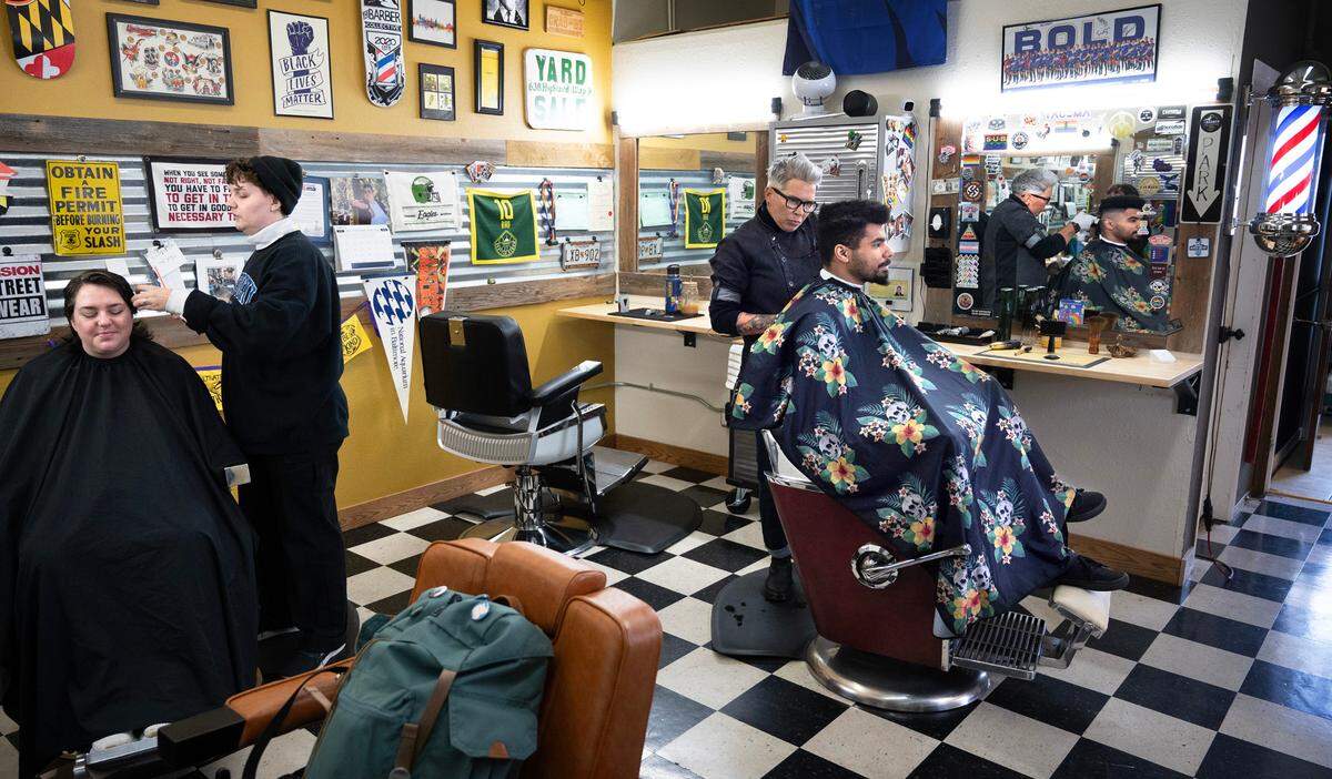 Cosmetologist Nae Lapp (standing left) and barber Georgette Watje work with clients Nicole Conner (far left) of Puyallup and Aether Kertzen of Tacoma at The Barber Collective in downtown Tacoma, Washington, on Thursday, March 7, 2024.