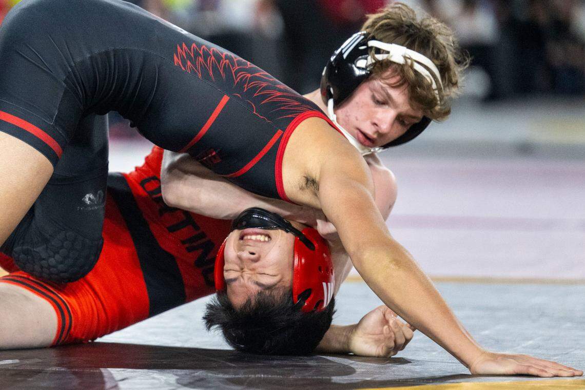 Orting’s Trevor Anderson bends Cleveland’s Reese Tanabe during their Class 2A, 120-pound match on Friday, Feb. 21, 2025, at Mat Classic XXXVI at the Tacoma Dome in Tacoma, Wash.