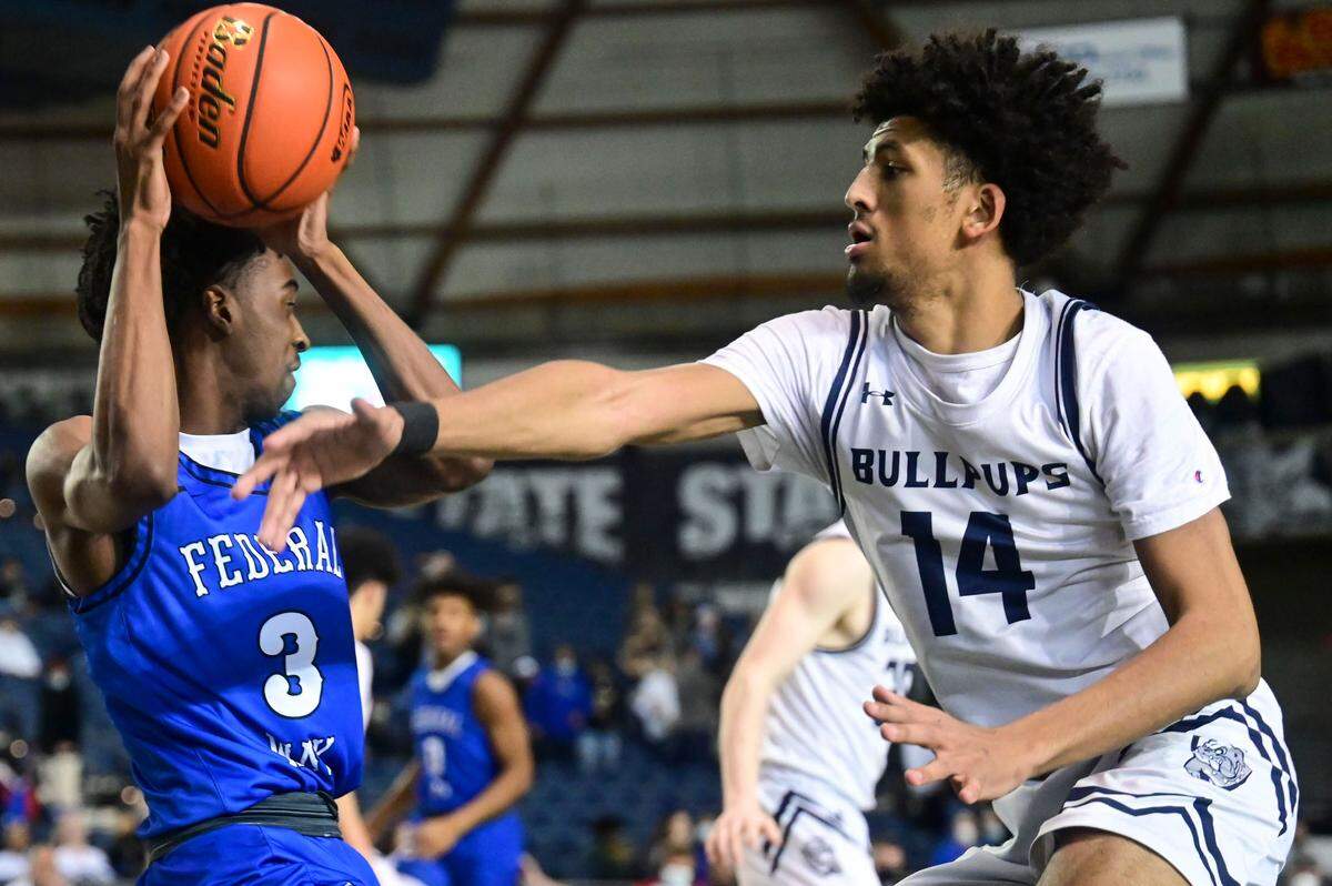 Gonzaga Prep forward Jayden Stevens (14) swipes at the ball as Federal Way wing Darius Williams (3) attempts to find dribbling space in the corner of the court during the first quarter of a Class 4A state tournament game on Wednesday, March 2, 2022, at the Tacoma Dome, in Tacoma, Wash.