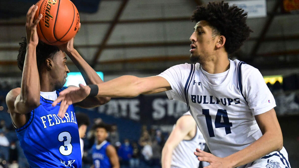 Gonzaga Prep forward Jayden Stevens (14) swipes at the ball as Federal Way wing Darius Williams (3) attempts to find dribbling space in the corner of the court during the first quarter of a Class 4A state tournament game on Wednesday, March 2, 2022, at the Tacoma Dome, in Tacoma, Wash.