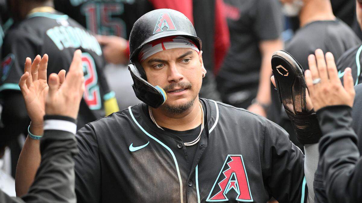 Jun 19, 2025; Toronto, Ontario, CAN;   Arizona Diamondbacks designated hitter Josh Naylor celebrates with team mates in the dugout after scoring a run against the Toronto Blue Jays in the sixth inning at Rogers Centre. Mandatory Credit: Dan Hamilton-Imagn Images
