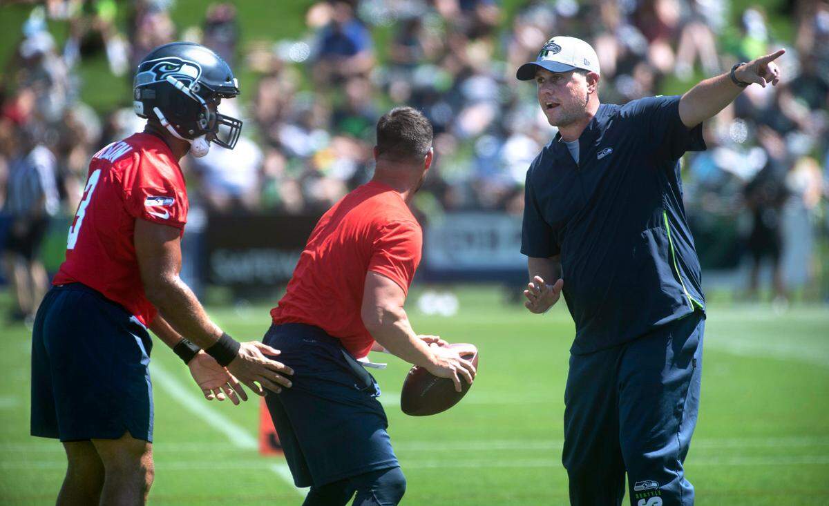 New offensive coordinator Shane Waldron directs quarterback Russell Wilson during Seattle Seahawks practice at the Virginia Mason Athletic Complex in Renton, Washington, on Thursday, July 29, 2021.