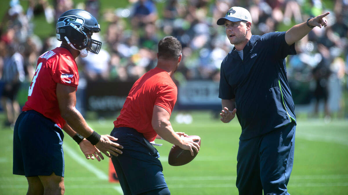 New offensive coordinator Shane Waldron directs quarterback Russell Wilson during Seattle Seahawks practice at the Virginia Mason Athletic Complex in Renton, Washington, on Thursday, July 29, 2021.