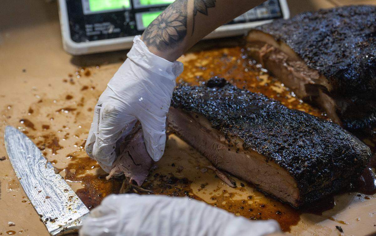 Brisket is sliced for an order at Dickey's Barbecue Pit on Thursday, Nov. 13, 2025, in Puyallup, Wash.