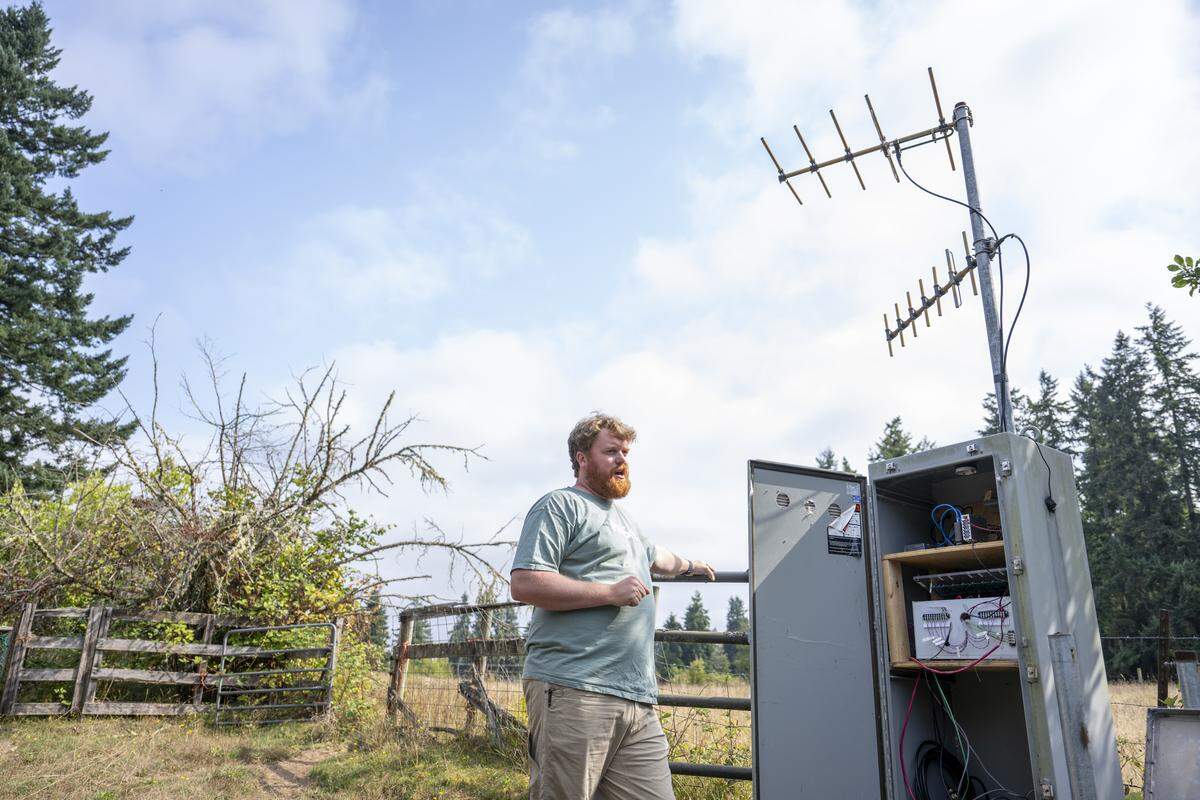 Doug Gibbons, a field technician and seismology lab coordinator for the Pacific Northwest Seismic Network, stands by one of the organization’s seismic stations on Thursday, Sept. 11, 2025, at a farm in Graham.