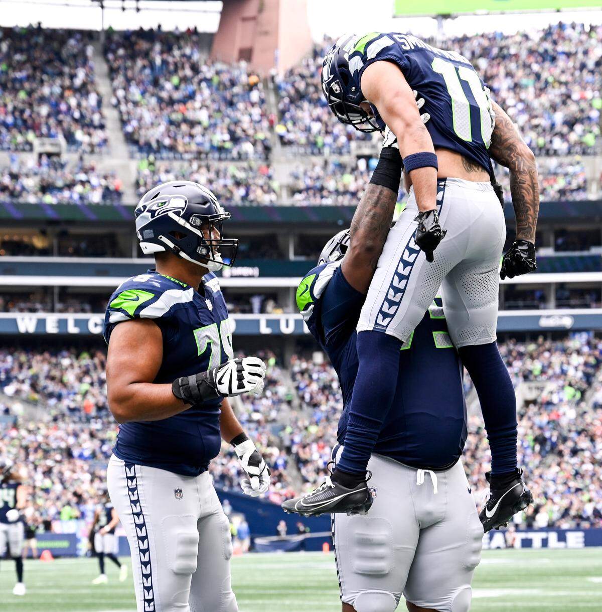 Seattle Seahawks wide receiver Jaxon Smith-Njigba (11) celebrates a touchdown with teammates during the first quarter of the game at Lumen Field, Sunday, Oct. 22, 2023, in Seattle, Wash.