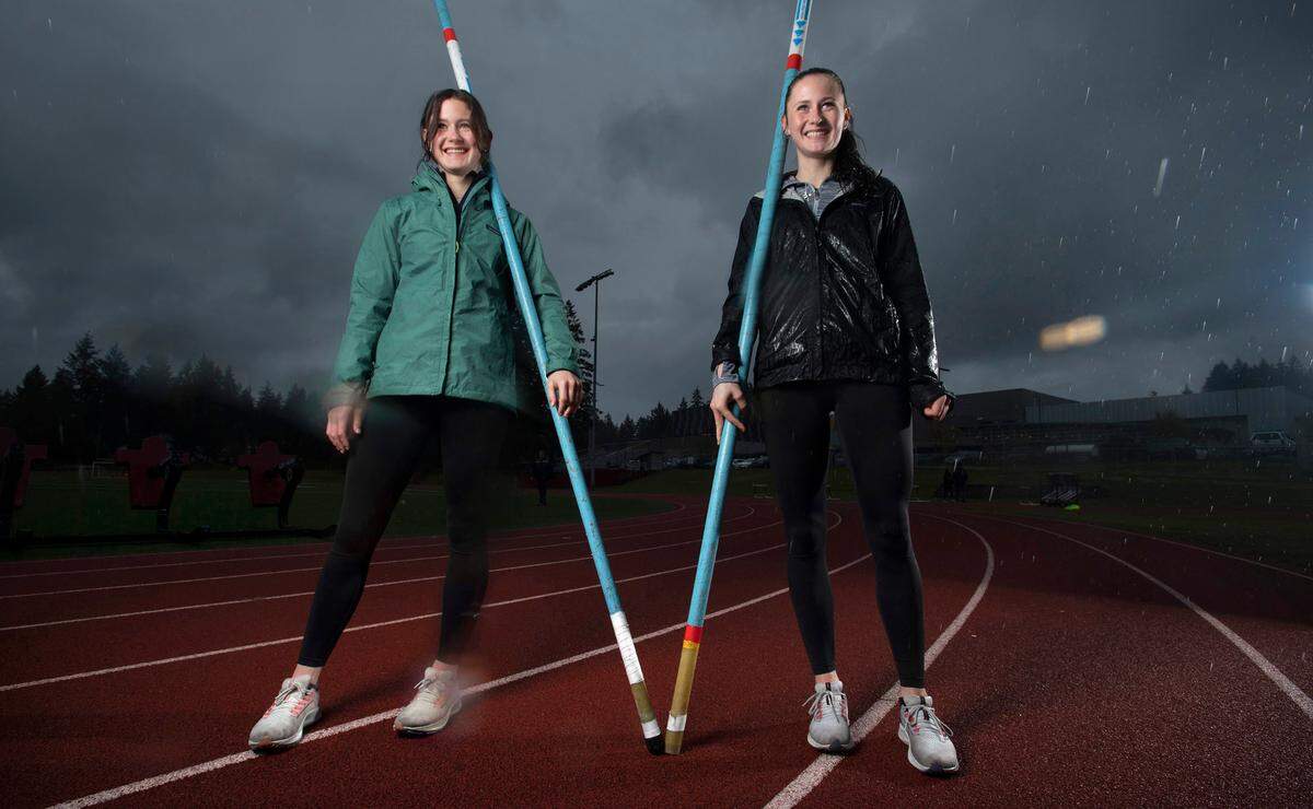 Capital High twin sisters Hana Moll (left) and Amanda Moll are leading the nation in high school girls pole vault, including Amanda’s national record vault of 14’ 9 1/2”. They are shown during a stormy practice at Capital High School in Olympia, Washington, on Monday, April 18, 2022.