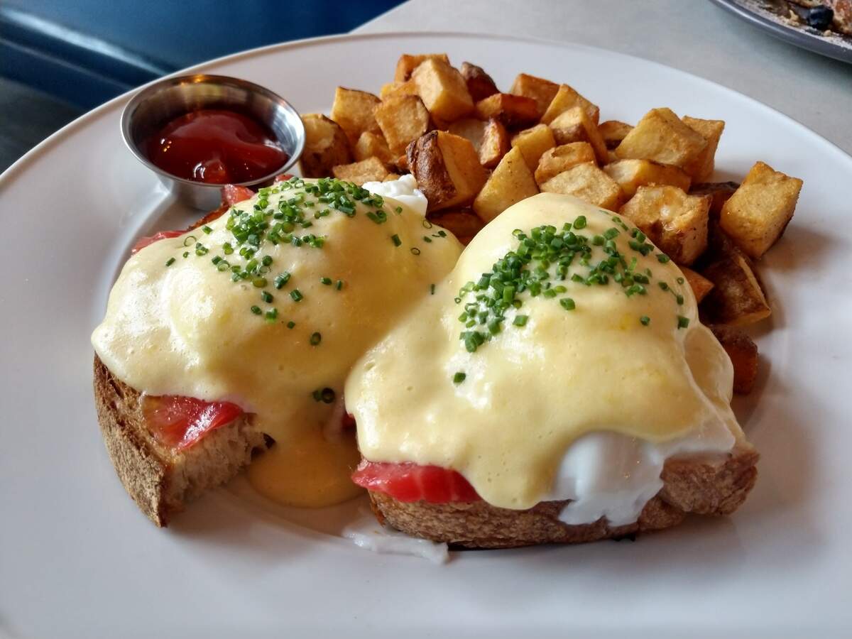 Salmon Benedict with a lemon-heavy hollandaise and breakfast potatoes.