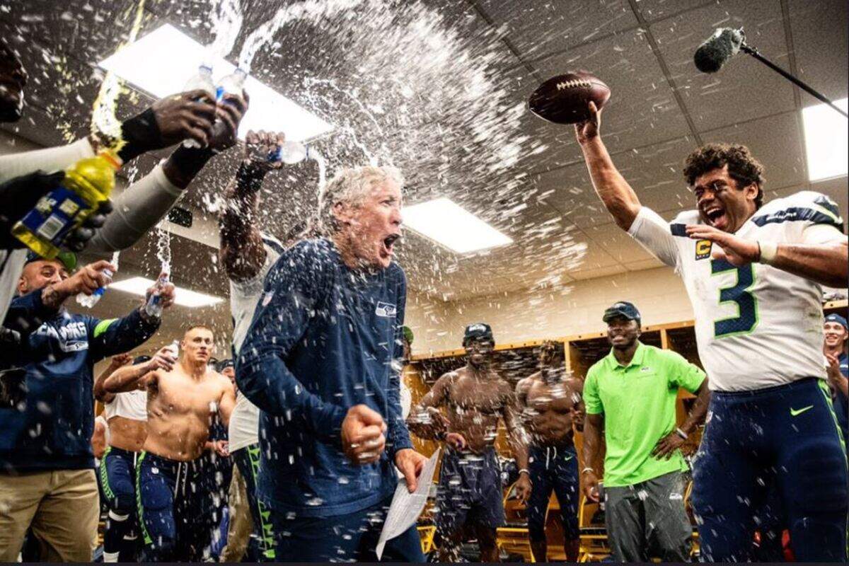 Coach Pete Carroll gets drenched by Russell Wilson (3) and his Seahawks teammates in the visiting locker room at Heinz Field in Pittsburgh following Carroll’s 100th NFL coaching victory on his 68th birthday.
