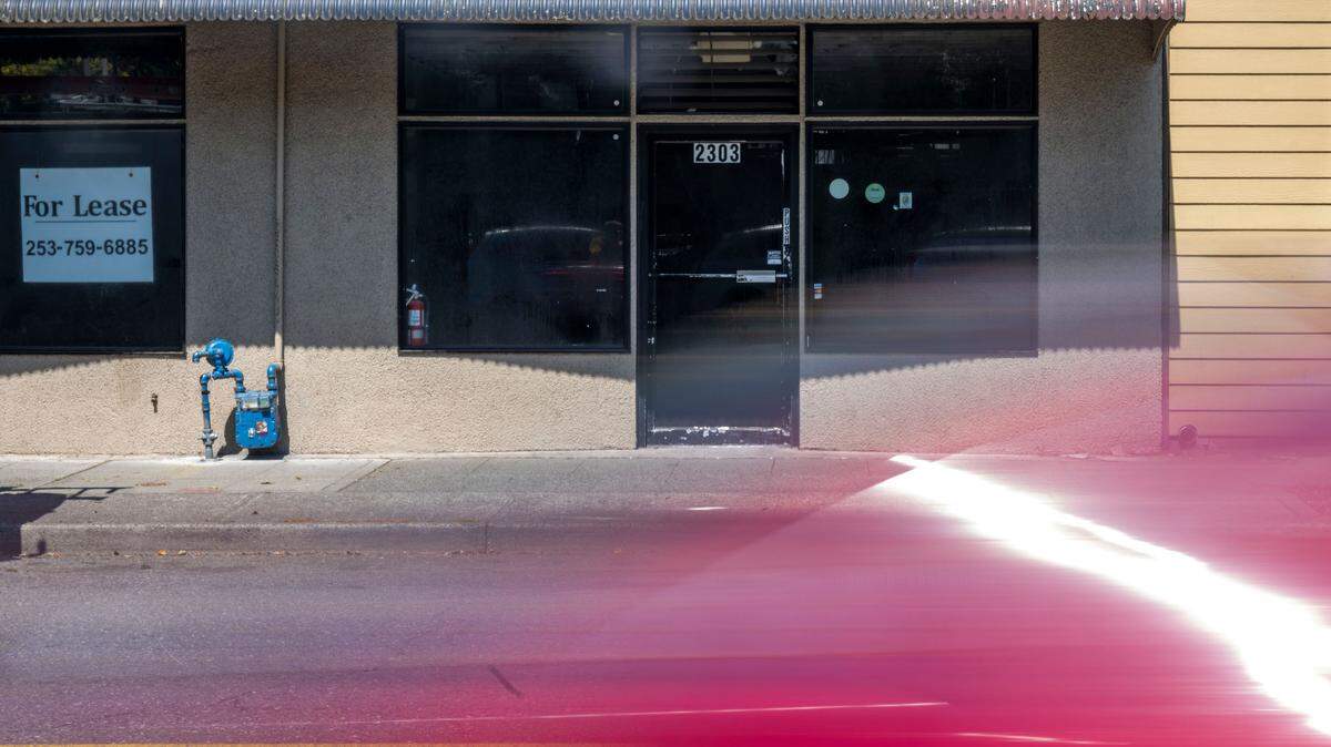 A car drives along Sixth Avenue in front of the former home to North China Garden in Tacoma on Wednesday, Aug. 7, 2024.