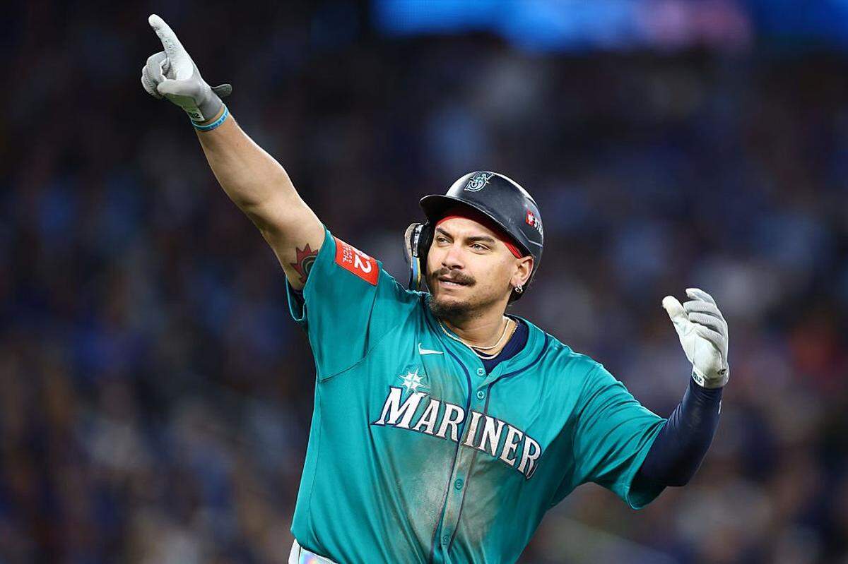 TORONTO, ONTARIO - OCTOBER 13: Josh Naylor #12 of the Seattle Mariners celebrates after hitting a two run home run against the Toronto Blue Jays during the seventh inning in game two of the American League Championship Series at Rogers Centre on October 13, 2025 in Toronto, Ontario.  (Photo by Vaughn Ridley/Getty Images)