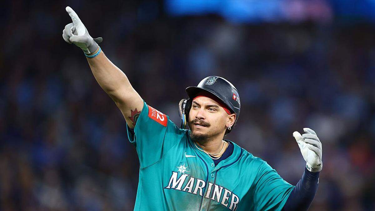 TORONTO, ONTARIO - OCTOBER 13: Josh Naylor #12 of the Seattle Mariners celebrates after hitting a two run home run against the Toronto Blue Jays during the seventh inning in game two of the American League Championship Series at Rogers Centre on October 13, 2025 in Toronto, Ontario. (Photo by Vaughn Ridley/Getty Images)