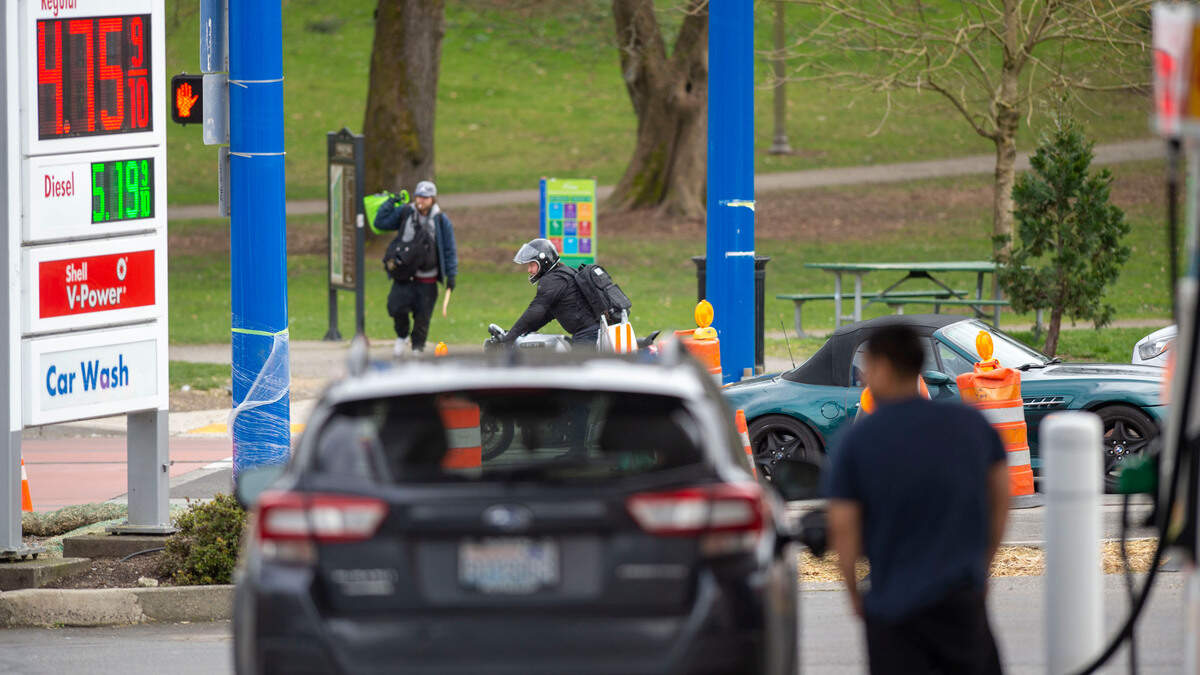 Gas prices are on the rise everywhere but $4.75 per gallon doesn’t deter a man filling up his car with gas as people drive past the Shell gas station on the 800 block of Division Avenue in Tacoma, Wash., on Monday, March 7, 2022.