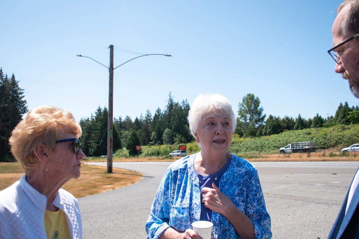 Maggie Garber, left, and Barbara Rogers, center, speak with Russ Weeks on July 12, 2024. Weeks co-owns Haven of Rest, a local memorial park and funeral home off state Route 16 in the Gig Harbor area. Garber and Rogers have family members there.