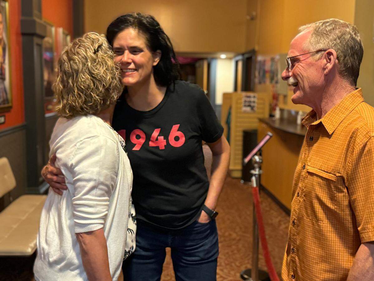 Teresa and Todd Silver greet “1946: The Mistranslation That Shifted Culture”&nbsp;director Sharon Roggio (center) after a screening of the film at Tacoma’s Grand Cinema on July 18, 2024.