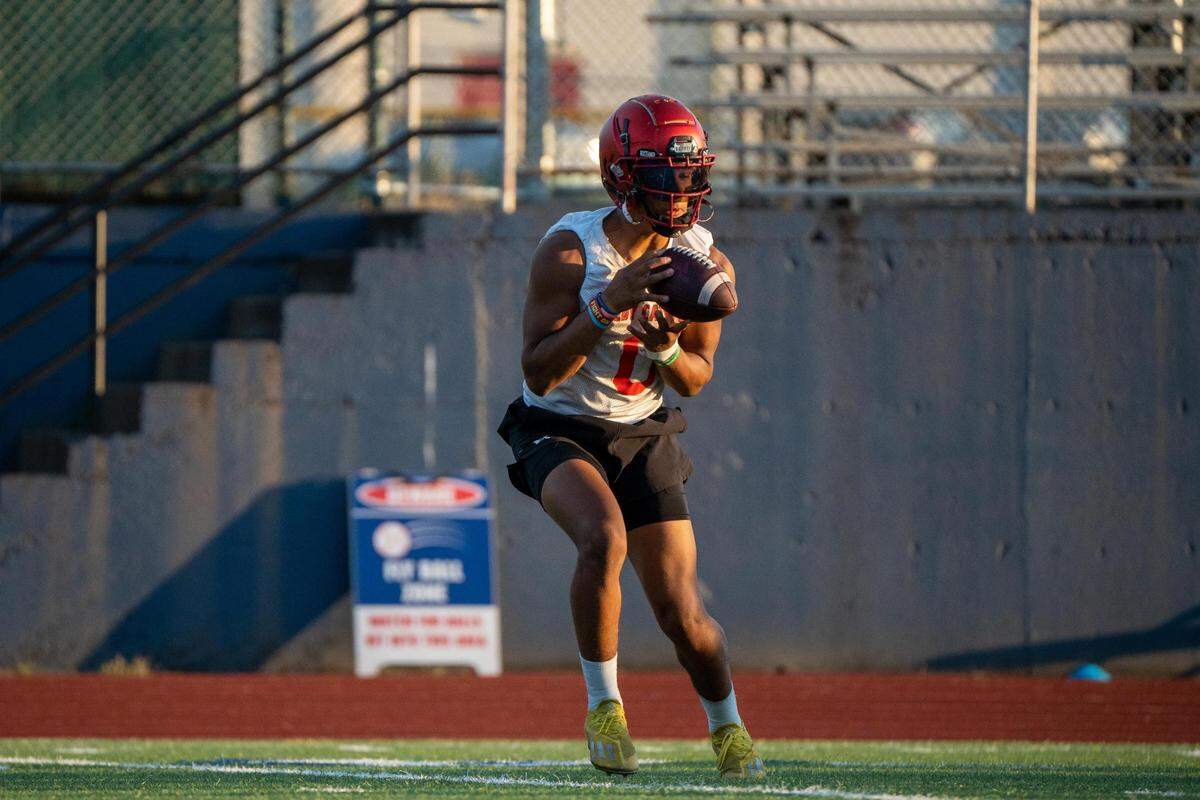 Kennedy Catholic Xe’ree Alexander receives a pass thrown by quarterback Devon Forehand during practice at the high school in Burien, Wash. on Wednesday Aug. 17, 2022.