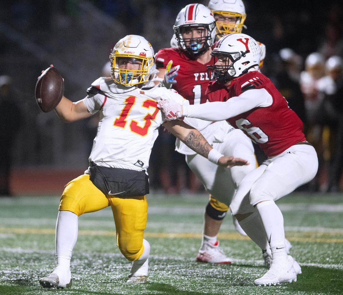 Mount Tahoma quarterback Tre Walker is sacked by Yelm linebacker Nathan Ford during Friday night’s 3A state quarterfinal football game at Yelm High School in Yelm, Washington, on Nov. 17, 2023. Yelm won the game, 29-12.