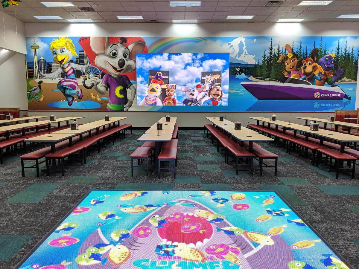 Chuck E. Cheese dropped ball pits and indoor playgrounds for games years ago. The Tacoma location now also features a large-format video wall and interactive dance floor.