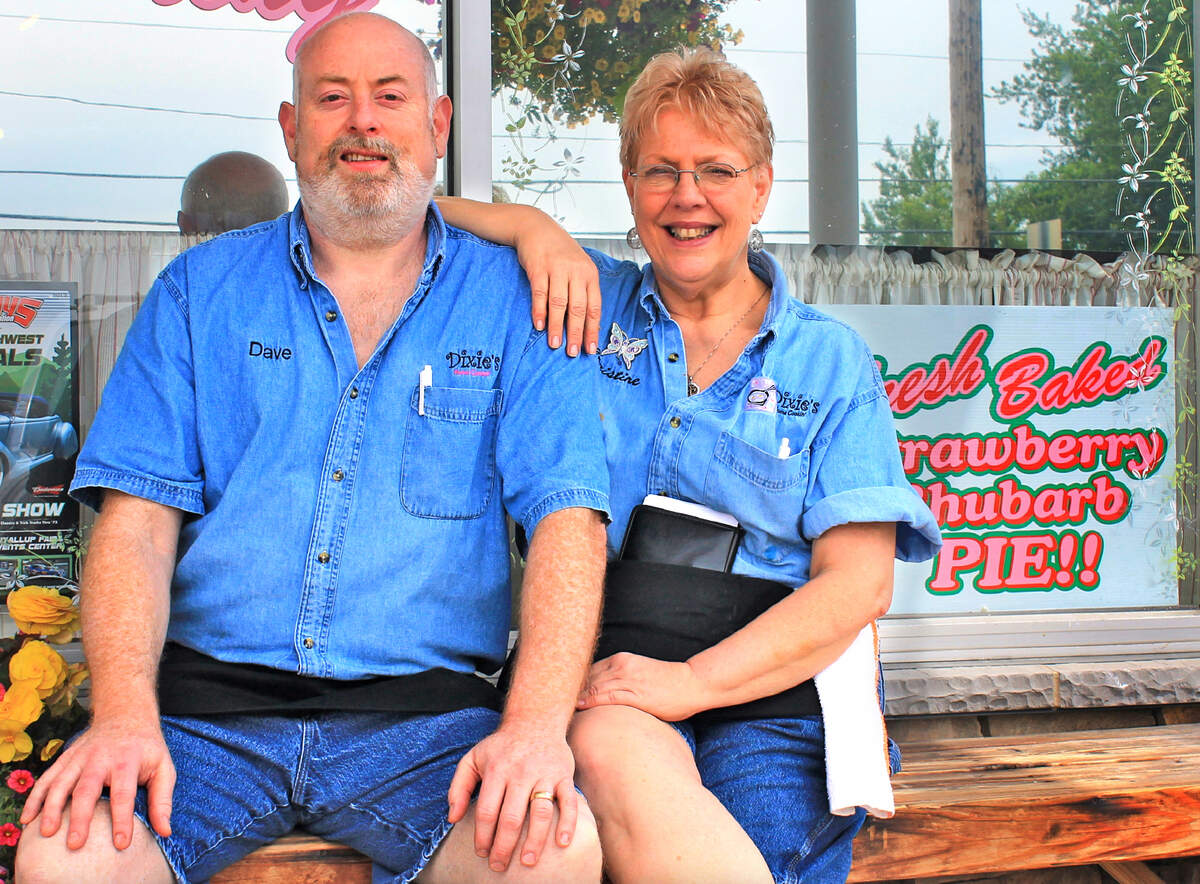 Dave and Christine Jacobs, owners of Dixie’s Home Cookin’, sit in front of their restaurant.