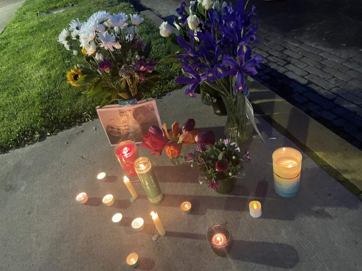 Friends and residents of the G Street Apartments placed candles and flowers in honor of the woman killed on Wednesday.