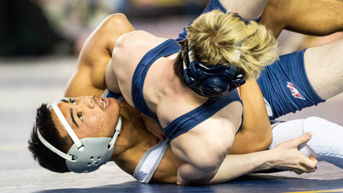Curtis’ Aizayah Yacapin wrestles Glacier Peak’s Gavin MacDonald during Mat Classic XXXI at the Tacoma Dome in Tacoma, Wash., on Friday, Feb. 15, 2019.