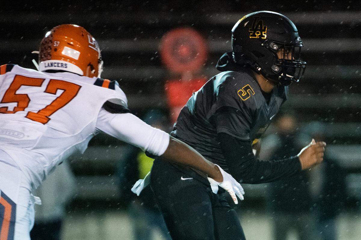 Lincoln’s Gabarri Johnson runs during the game. Lincoln played Lakes in a football game at the Lincoln Bowl in Tacoma, Wash., on Friday, March 19, 2021.