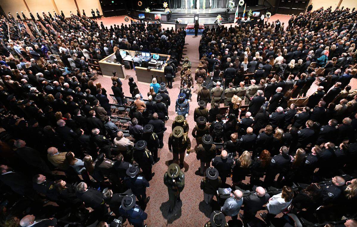 Color Guard members leave the auditorium after placing flags during the celebration of life ceremony for Pierce County sheriff’s deputy Dom Calata at Church For All Nations in Parkland, Washington, on Friday, March 25, 2022.