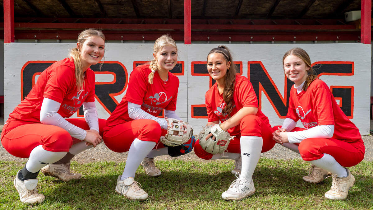 Orting High School softball players (from left) senior pitcher Kaylee Gresko, junior catcher Miken Jacobsen, senior shortstop Abbi Almont, and sophomore third baseman Madalynn Halte, pose for a portrait in Orting, Wash., on Monday, April 24, 2023.