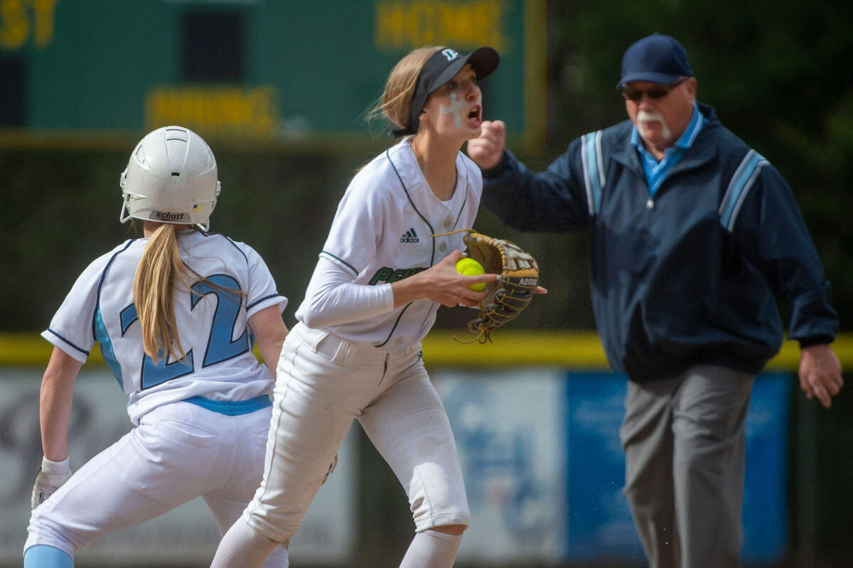 Peninsula shortstop Glory Estabrook celebrates after tagging out Gig Harbor’s Danielle Biehl on a stolen base attempt to end the top of the third inning of a 3A South Sound Conference game on Wednesday, April 6, 2022, at Peninsula High School in Gig Harbor, Wash.