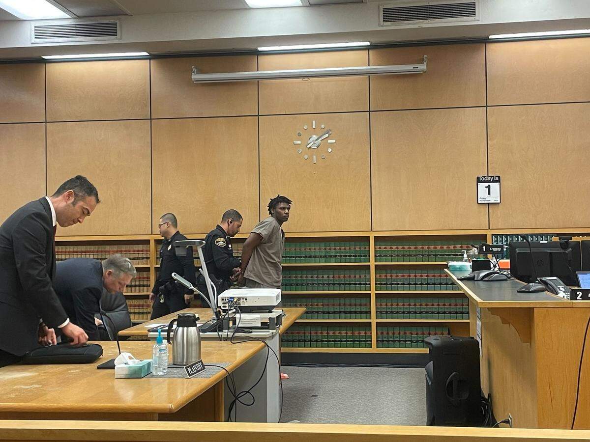 Devonte Jayquan Pool, 18, is handcuffed on Friday, Nov. 1, 2024, before being led out of a Pierce County Superior Courtroom where he was sentenced to 20 years in state custody for the March 29, 2023 fatal shooting of Larry “Trae” Marshall III. Pool and one other defendant have pleaded guilty to second-degree murder for the killing, and a third defendant’s case is pending.