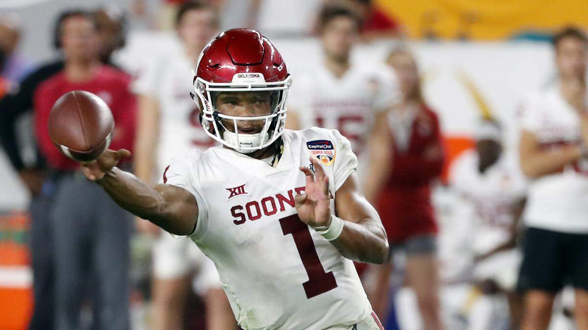 FILE - In this Dec. 29, 2018, file photo, Oklahoma quarterback Kyler Murray throws a pass during the second half of the Orange Bowl NCAA college football game against Alabama in Miami Gardens, Fla. The Oakland Athletics remain hopeful of seeing Heisman Trophy winner Murray in their baseball uniform when spring training begins next month. While the Oklahoma quarterback declared for the NFL draft last week, the prized outfielder could report to A’s spring training in Mesa, Arizona--and he has an invite to big league camp. (AP Photo/Wilfredo Lee, File)