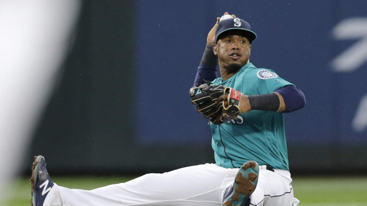 Seattle Mariners shortstop Jean Segura throws the ball to second from the ground to force out Kansas City Royals' Whit Merrifield during the second inning of a baseball game Friday, June 29, 2018, in Seattle. (AP Photo/John Froschauer)