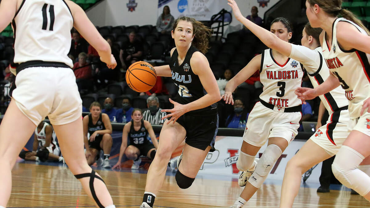 Western Washington guard Emma Duff drives to the basket against a Valdosta State defender in a NCAA Division II national quarterfinals game on Monday, March 21, 2022 in Birmingham, Ala.