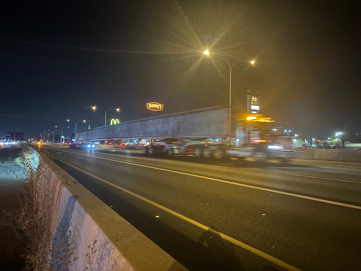 A truck delivers one of the 15 concrete girders for a bridge over Interstate 5 in Fife on Oct. 6, 2024. It’s part of the State Route 167 Completion Project.
