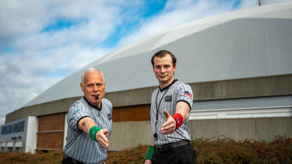 The father-son officiating team of Bob Turner, 60, and Andrew Turner, 24, pose for a portrait outside the Tacoma Dome on Wednesday, Feb. 16, 2022, in Tacoma, Wash. Bob Turner, of Tacoma, has been officiating wrestling for 33 years including 15 WIAA Mat Classics. While Andrew Turner, of Seattle, has been officiating wrestling for 10 years and Friday will be his first Mat Classic.