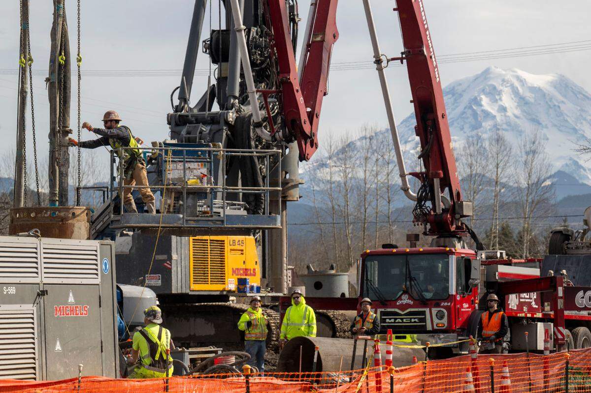 Construction crews work on the foundation of the Bridge for Kids on Wednesday, Feb. 26, 2025, in Orting, Wash. The bridge is the first of two planned projects allowing residents to find higher ground in case of a flood or lahar.