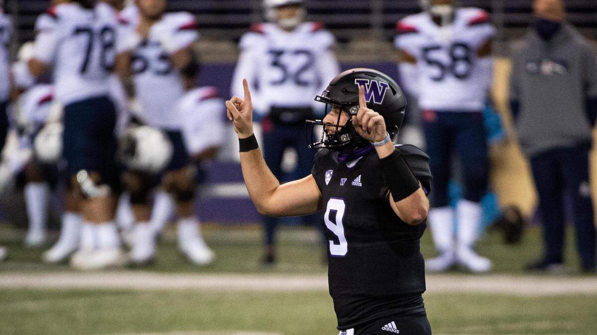 Washington quarterback Dylan Morris celebrates a touchdown run by Richard Newton in the second quarter. The Washington Huskies played the Arizona Wildcats in a PAC-12 football game at Husky Stadium in Seattle, Wash., on Saturday, Nov. 21, 2020.