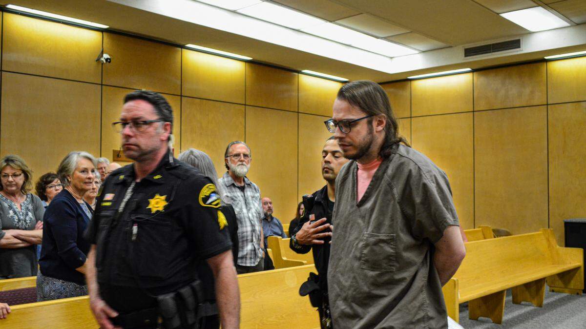 Ezra Fleming Ralston, 29, is led way in Pierce County Superior Court on Friday, June 16, 2023 after a judge handed him two life sentences in prison without possibility of parole, plus additional time. Ralston was convicted in a jury trial of conspiring with three others to murder his grandparents in 2020 and burn their Vaughn home.