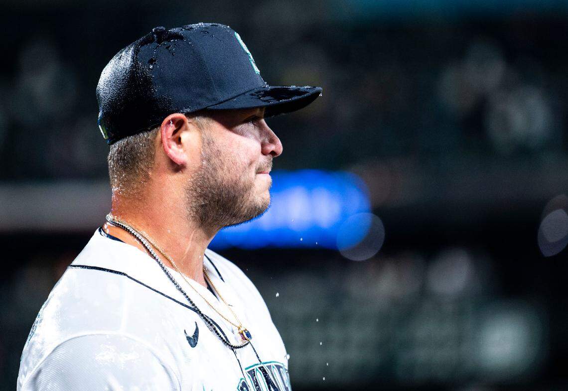 Seattle Mariners first baseman Ty France (23) is drenched with water after hitting a homer in the eighth inning that scored three runs and helped the Mariners win their home opener against the Cleveland Guardians 3-0 at T-Mobile Park in Seattle on Thursday, March 30, 2023.