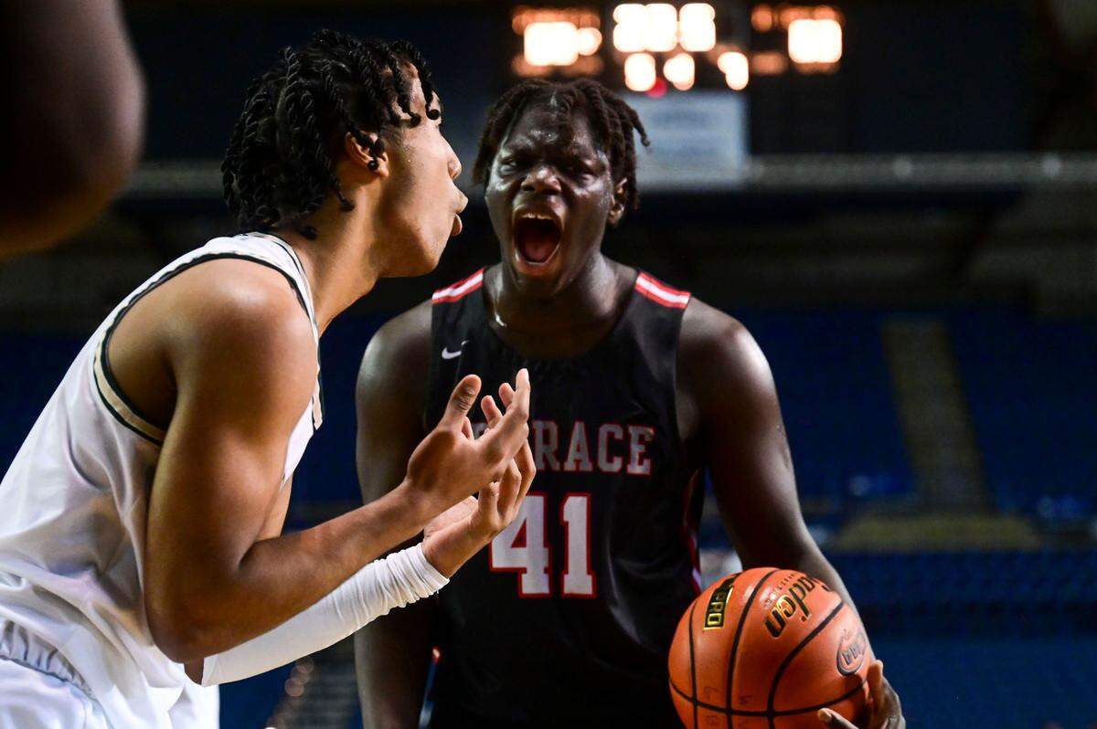Timberline guard Miles Gurske (2) reacts after a foul wasn’t called on his contested layup attempt as Mountlake Terrace forward Zaveon Jones (41) celebrates the referee’s decision late in the fourth quarter of a Class 3A state tournament game on Wednesday, March 2, 2022, at the Tacoma Dome, in Tacoma, Wash.