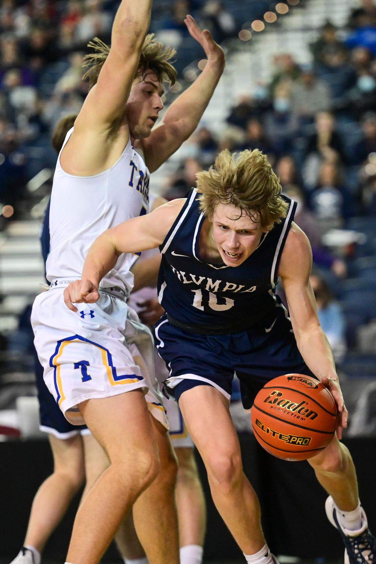 Olympia guard Drew Carlson (10) dribbles along the baseline as Tahoma guard Gavin Garcia (3) defends during the fourth quarter of a Class 4A quarterfinal state tournament game on Thursday, March 3, 2022, at the Tacoma Dome, in Tacoma, Wash.