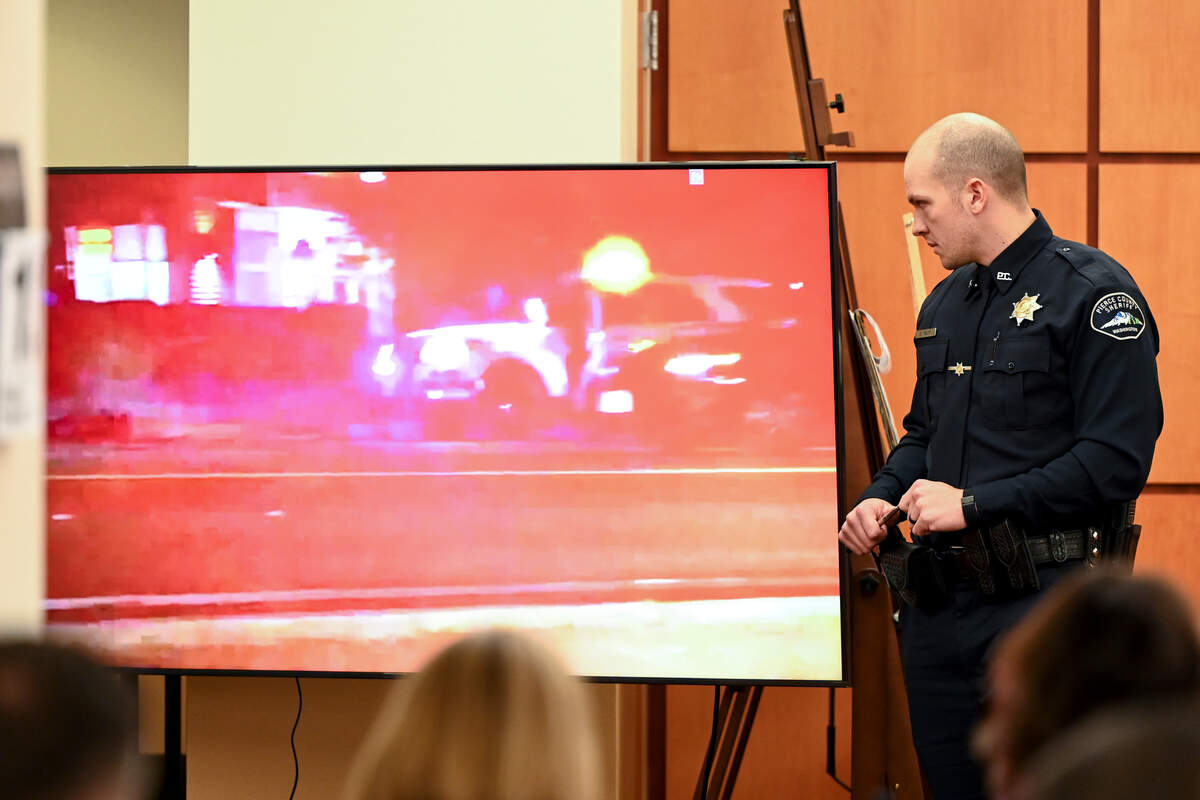 Pierce County Sheriff’s Deputy Arron Wolfe describes what is occurring in a video of a 2019 incident involving Manny Ellis during the trial of three Tacoma Police officers in the killing of Manny Ellis at Pierce County Superior Court, Monday, Nov. 13, 2023, in Tacoma, Wash. Tacoma Police Officers Christopher Burbank, Matthew Collins and Timothy Rankine stand trial for charges related to the March 2020 killing of Manny Ellis. (Brian Hayes / Pool Photo – The News Tribune)