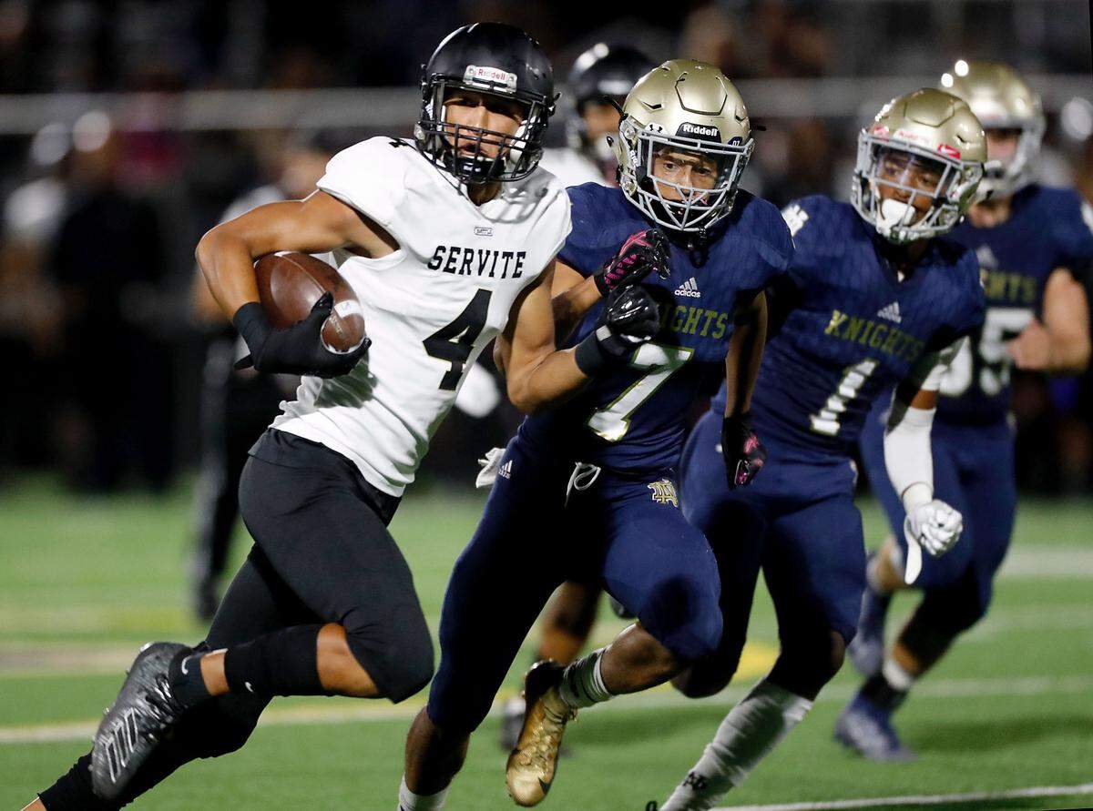 Servite High School wide receiver Tetairoa McMillan (4) runs after a catch in a game against Sherman Oaks.